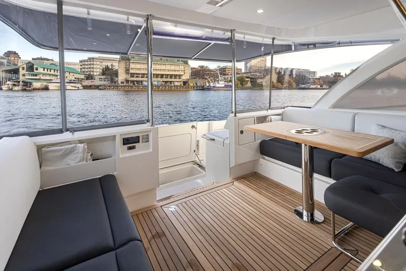 Slide: The Image of 2024 Riviera 46 Sports Motor Yacht interior with waterfront view. - 34