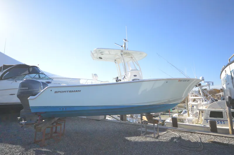 Slide: The Image of 2015 Sportsman 25 Center Console boat on display in a marina. - 1