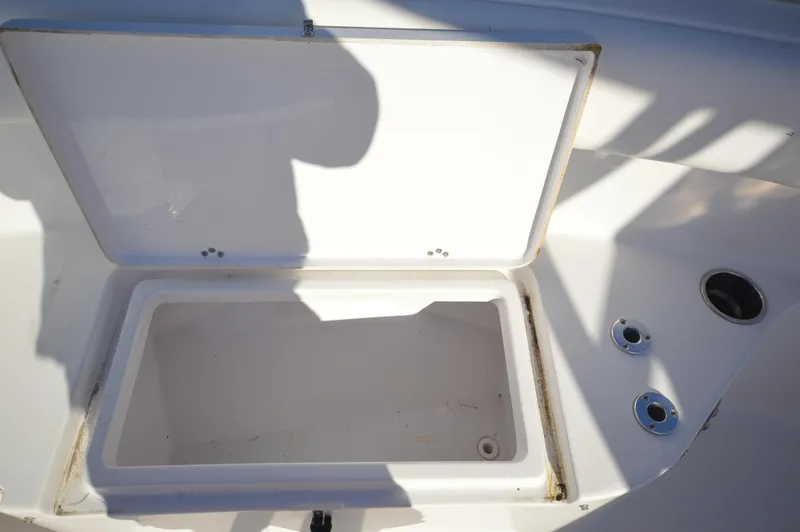 Slide: The Image of Open storage compartment on a 2015 Sportsman 25 Center Console boat. - 11