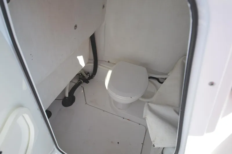 Slide: The Image of 2015 Sportsman 25 Center Console boat interior with marine toilet. - 13