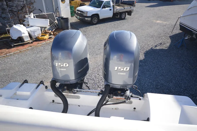 Slide: The Image of 2015 Sportsman 25 Center Console with twin Yamaha 150 outboard engines. - 23