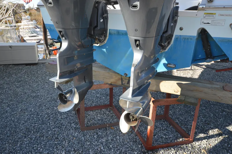 Slide: The Image of Twin outboard motors on a 2015 Sportsman 25 Center Console boat. - 25