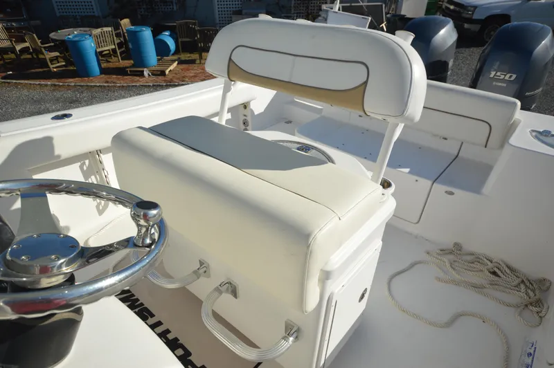 Slide: The Image of 2015 Sportsman 25 Center Console boat interior with steering wheel and seating. - 27