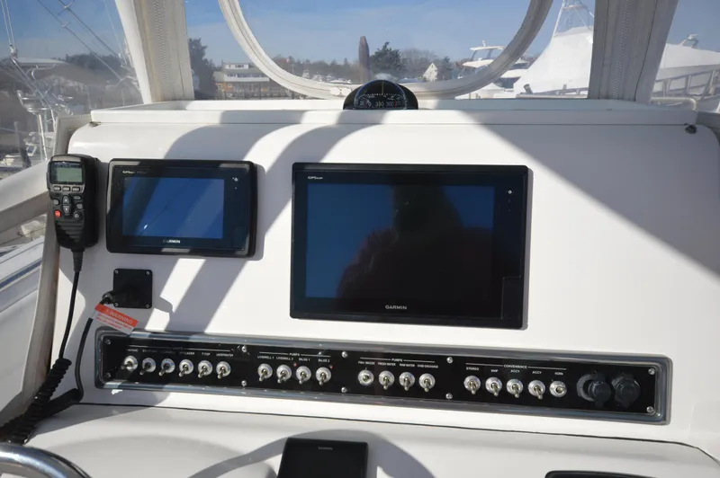 Slide: The Image of 2015 Sportsman 25 Center Console boat dashboard with navigation screens and control panel. - 35