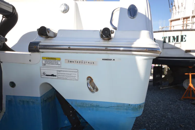Slide: The Image of 2015 Sportsman 25 Center Console boat stern with identification numbers and warning labels. - 5