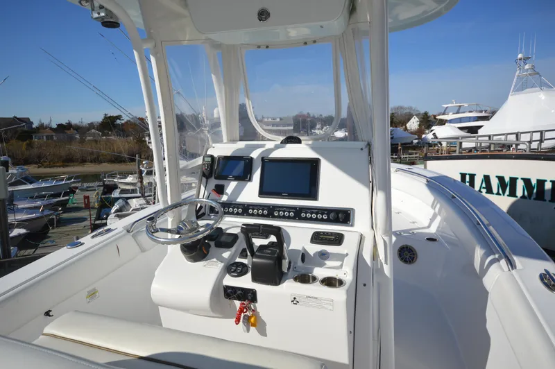 Slide: The Image of 2015 Sportsman 25 Center Console boat dashboard with navigation equipment. - 8