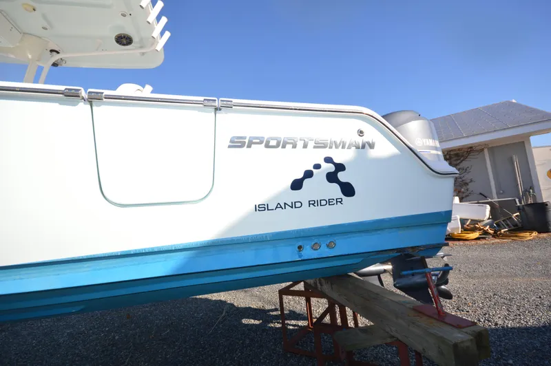 Slide: The Image of 2015 Sportsman 25 Center Console boat named Island Rider on a stand. - 9