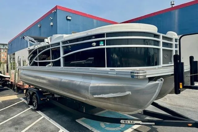 Slide: The Image of 2022 Barletta Corsa 21QC pontoon boat on trailer, parked outdoors. - 15