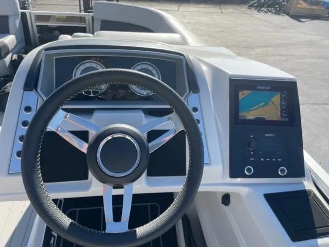 Slide: The Image of 2022 Barletta Corsa 21QC boat dashboard with steering wheel and navigation system. - 2