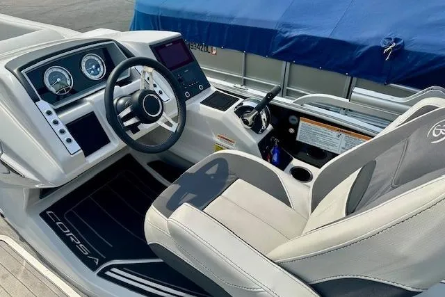 Slide: The Image of 2022 Barletta Corsa 21QC boat interior with steering wheel and dashboard controls. - 21
