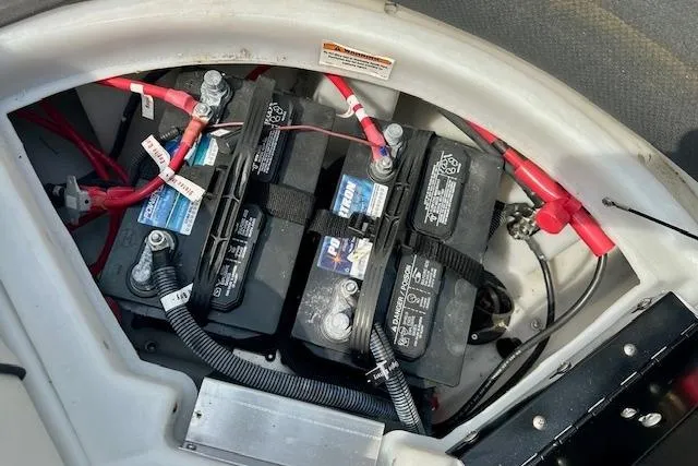 Slide: The Image of Battery compartment of a 2022 Barletta Corsa 21QC boat with multiple batteries and wiring. - 27
