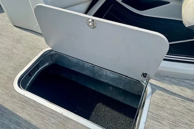 Slide: The Image of Open storage compartment in 2022 Barletta Corsa 21QC boat interior. - 32