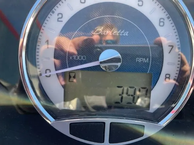 Slide: The Image of Close-up of 2022 Barletta Corsa 21QC RPM gauge showing 397 hours. - 4