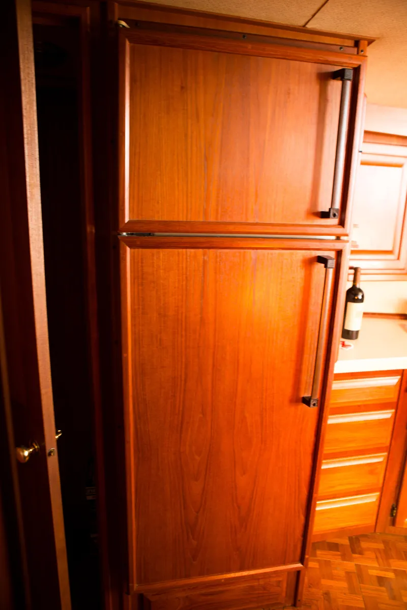 Slide: The Image of Wooden cabinetry in the kitchen of a 1986 Viking 41 boat. - 17