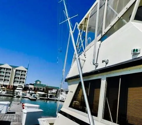 Slide: The Image of 1986 Viking 41 yacht docked at a marina with buildings in the background. - 2