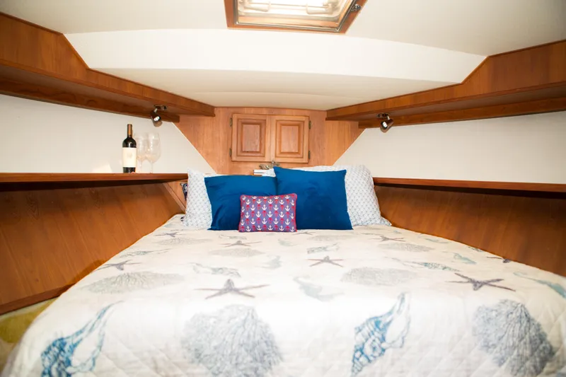 Slide: The Image of Cozy bedroom in a 1986 Viking 41 yacht with nautical-themed bedding. - 21