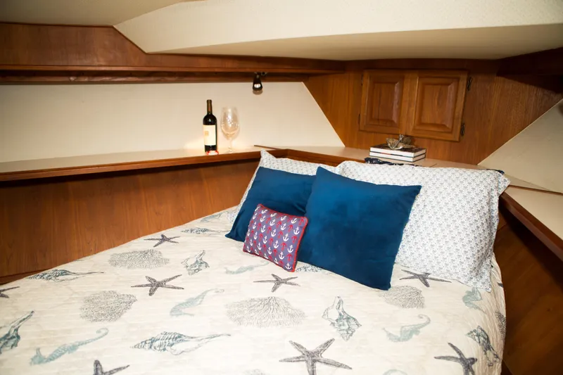 Slide: The Image of Cozy bedroom in a 1986 Viking 41 yacht with nautical-themed bedding. - 22