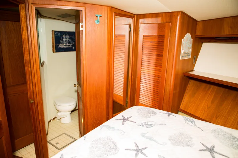 Slide: The Image of Interior of 1986 Viking 41 boat with wooden cabinets and a small bathroom. - 25