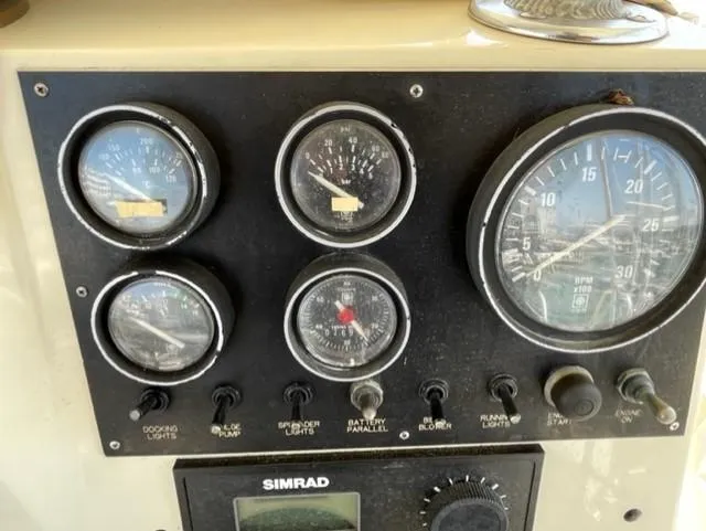 Slide: The Image of Control panel of a 1986 Viking 41 boat with gauges and switches. - 30