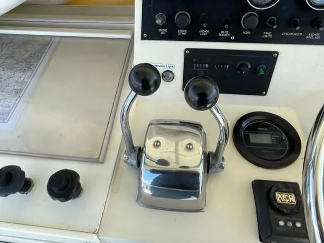 Slide: The Image of 1986 Viking 41 boat control panel with throttle and navigation instruments. - 31