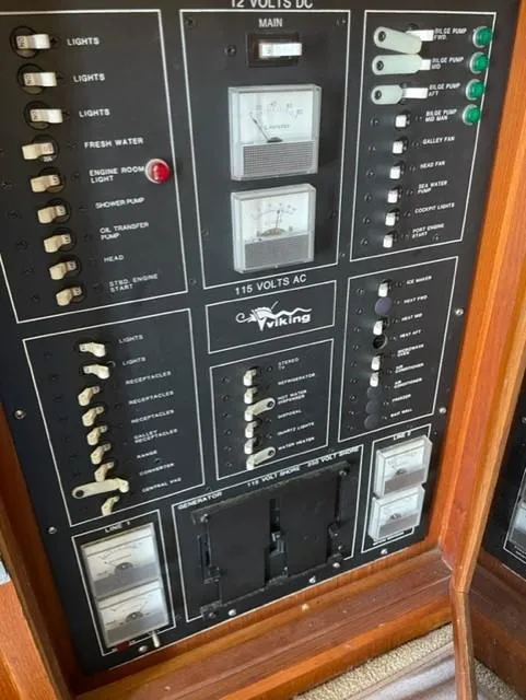 Slide: The Image of 1986 Viking 41 electrical control panel with switches and meters. - 38