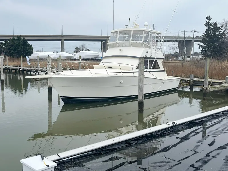 Slide: The Image of 1986 Viking 41 yacht docked in a marina, calm water, overcast sky. - 43