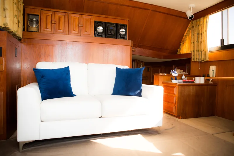 Slide: The Image of Interior of 1986 Viking 41 yacht with white sofa and blue pillows. - 5