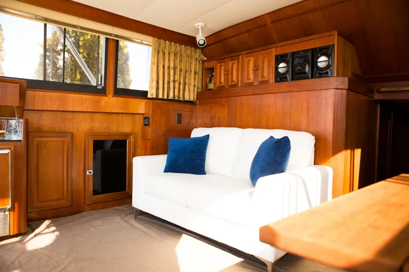 Slide: The Image of Interior of 1986 Viking 41 yacht with white sofa and blue pillows. - 6