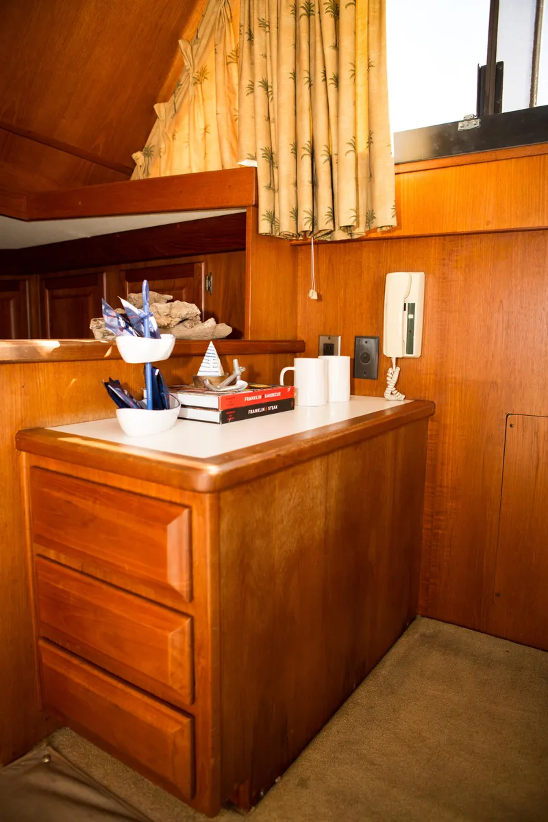 Slide: The Image of Interior of 1986 Viking 41 boat with wooden cabinetry and countertop accessories. - 8