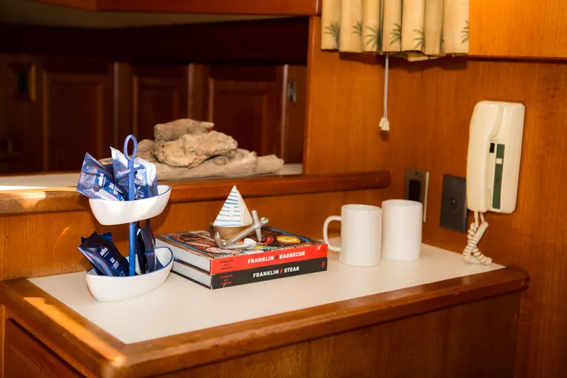 Slide: The Image of 1986 Viking 41 yacht interior with books, coffee mugs, and nautical decor. - 9
