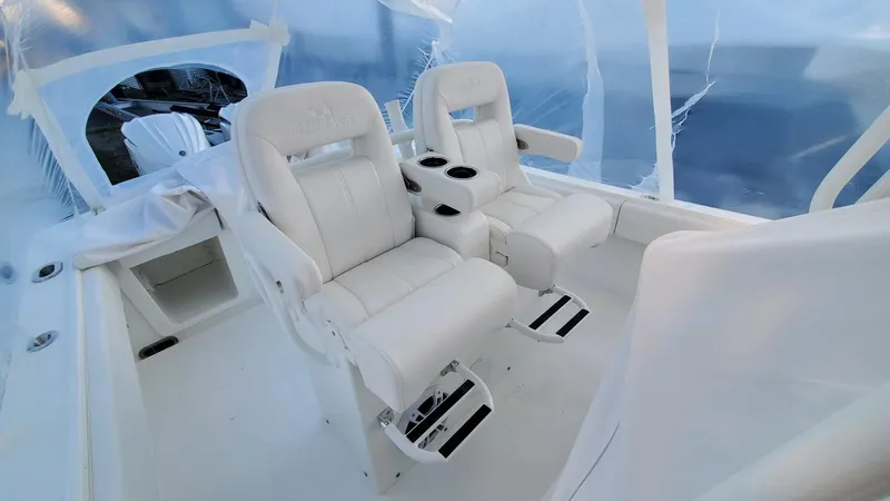 Slide: The Image of 2023 Regulator 28 boat interior with two white captain's chairs and cup holders. - 10