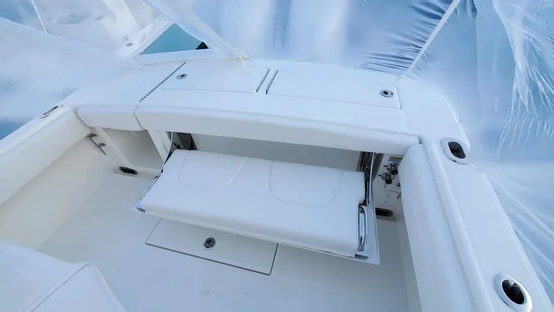 Slide: The Image of 2023 Regulator 28 boat interior with white seating and storage compartments. - 20