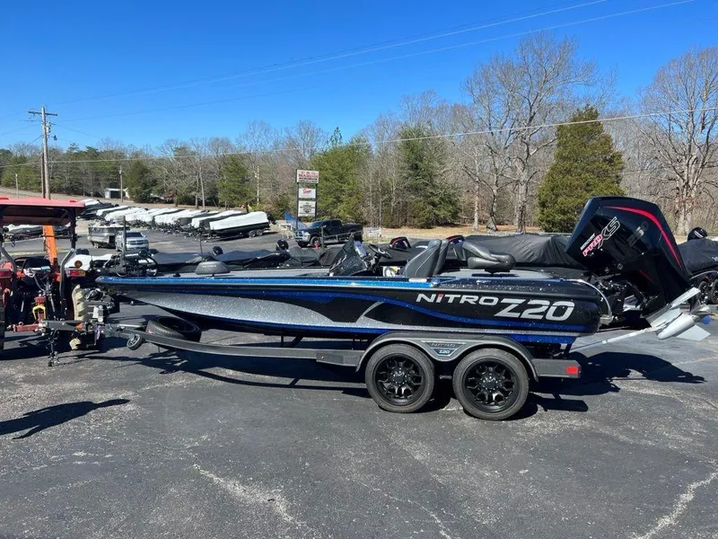 The Image of 2023 Nitro Z20 Pro boat on a trailer in a parking lot. - 1