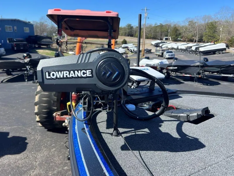 Slide: The Image of Lowrance fishfinder on a 2023 Nitro Z20 Pro boat, parked near trailers and a tractor. - 14