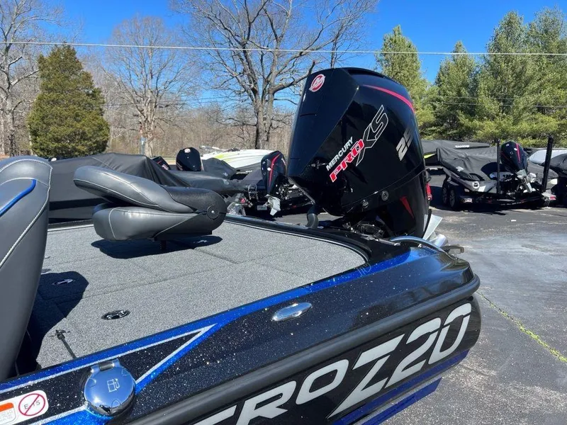 Slide: The Image of 2023 Nitro Z20 Pro boat with Mercury Pro XS engine in a parking lot. - 2