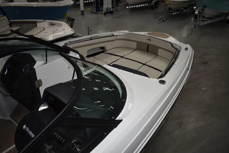 Slide: The Image of 2023 Monterey M6 boat interior with beige seating and sleek design in showroom. - 11