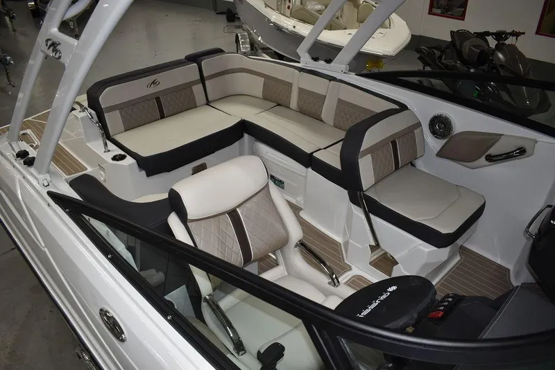 Slide: The Image of 2023 Monterey M6 boat interior with beige and black seating. - 12