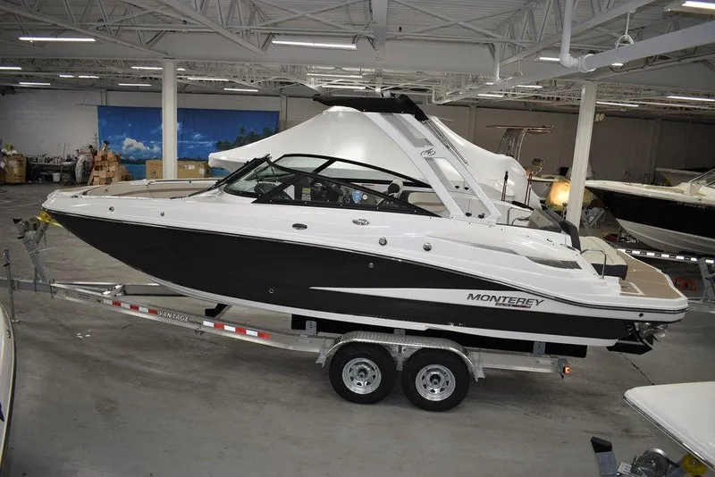 Slide: The Image of 2023 Monterey M6 boat on a trailer in a showroom. - 2