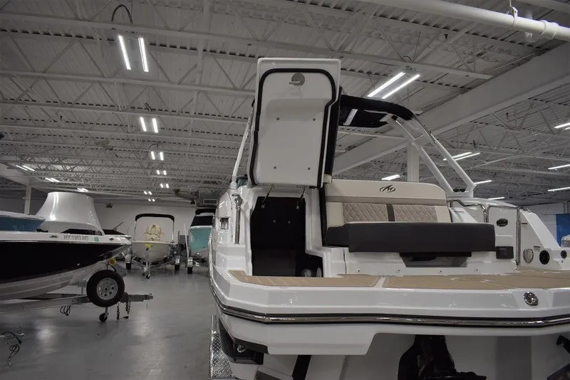 Slide: The Image of 2023 Monterey M6 boat in showroom, rear view with open hatch. - 20