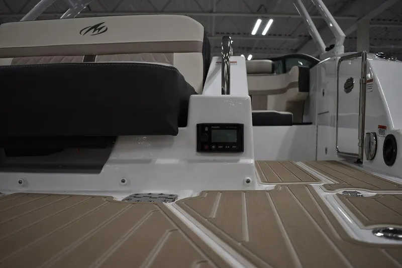 Slide: The Image of 2023 Monterey M6 boat interior with beige and black seating. - 21