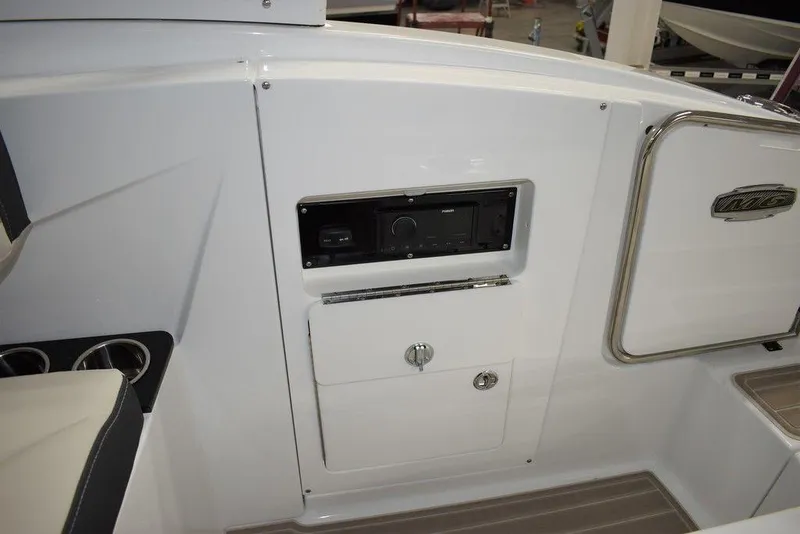 Slide: The Image of 2023 Monterey M6 boat interior with control panel and storage compartments. - 27
