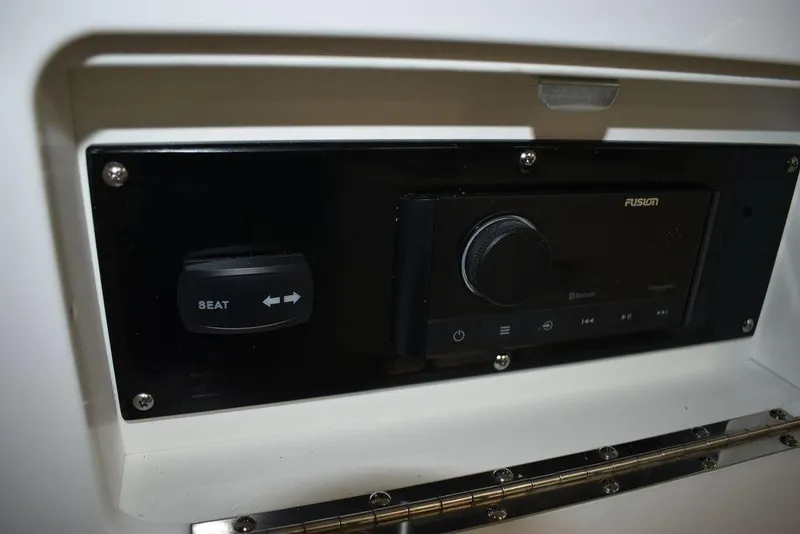 Slide: The Image of 2023 Monterey M6 boat control panel with seat adjustment and Fusion audio system. - 28