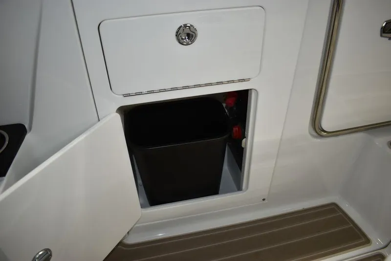 Slide: The Image of 2023 Monterey M6 boat storage compartment with trash bin. - 29