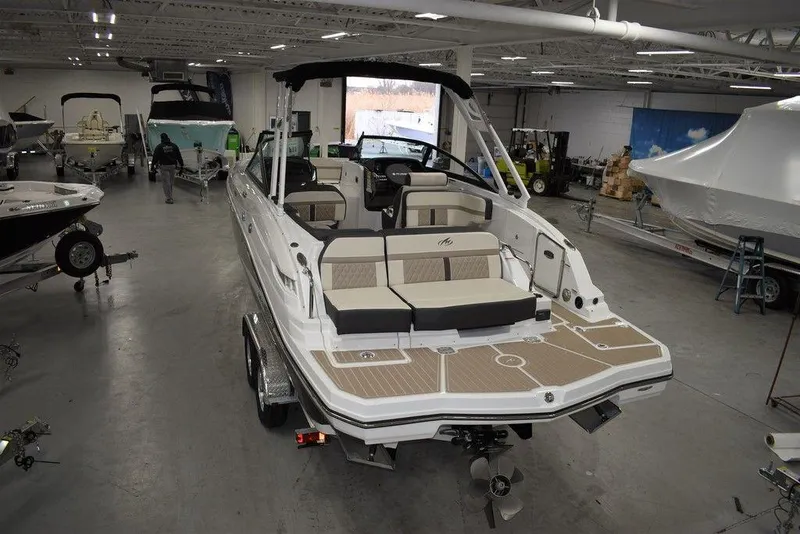 Slide: The Image of 2023 Monterey M6 boat in showroom, rear view with seating and deck. - 3