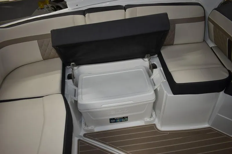 Slide: The Image of 2023 Monterey M6 boat interior with cushioned seating and built-in cooler. - 32