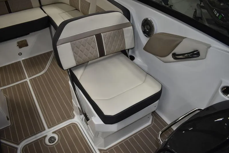 Slide: The Image of 2023 Monterey M6 boat interior with beige and brown seating and wood-patterned flooring. - 35