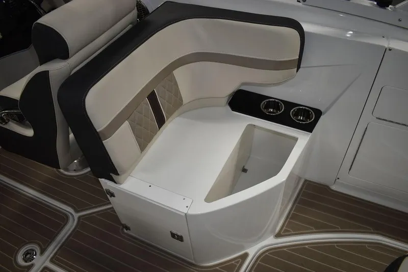 Slide: The Image of 2023 Monterey M6 boat interior seating with storage and cup holders. - 38