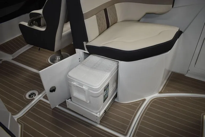 Slide: The Image of 2023 Monterey M6 boat interior with built-in cooler storage under seat. - 39