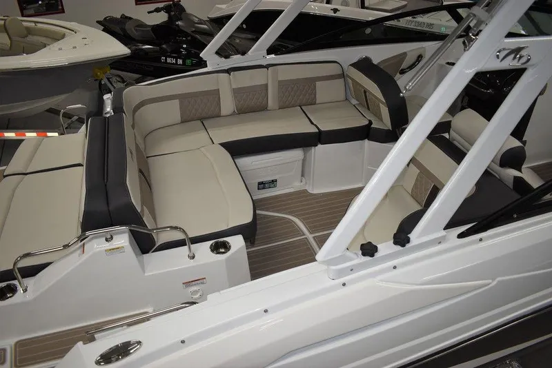 Slide: The Image of 2023 Monterey M6 boat interior with beige and black seating. - 8