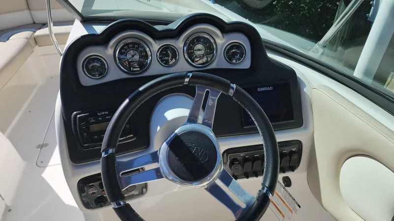 Slide: The Image of 2017 NauticStar 243DC Sport Deck boat dashboard with steering wheel and gauges. - 12